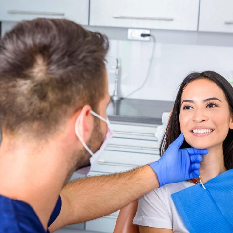 Dentist checking patient smile alignment