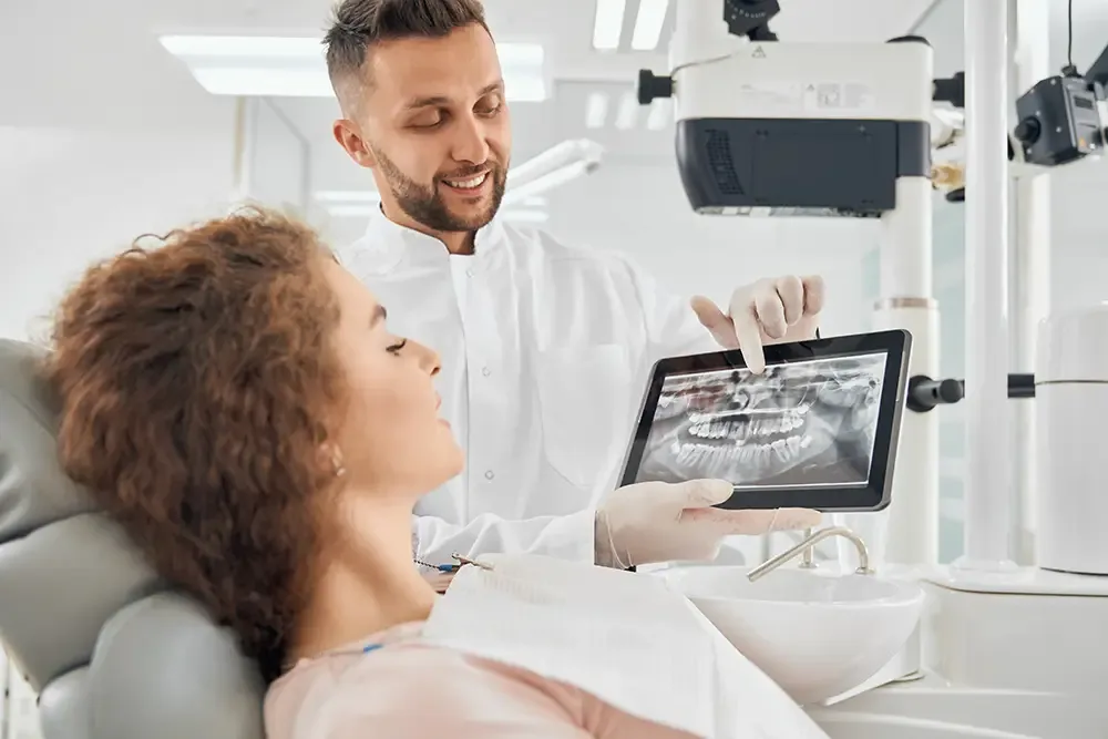 Dentist showing digital scan to patient