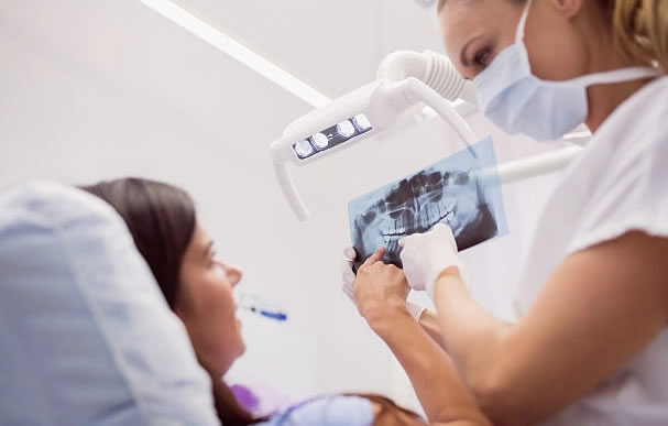 Dentist showing X-ray results