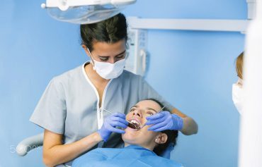 Dentist examining patient